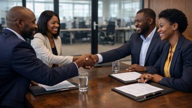 business teams shaking hands after signing a contract in a corporate boardroom